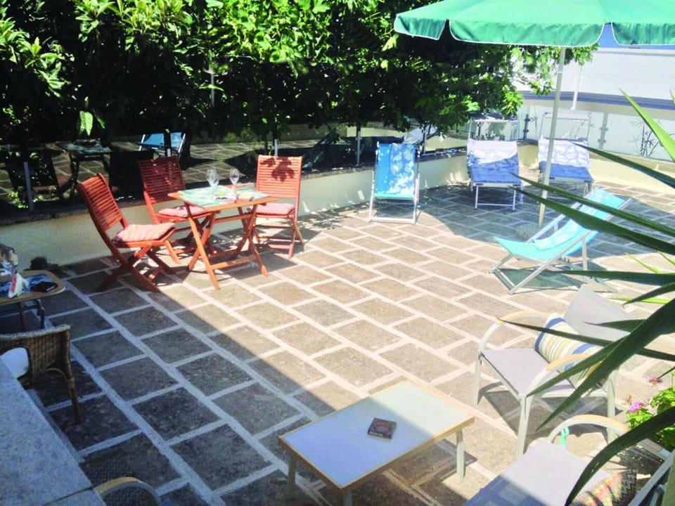 Terrace solarium equipped with sitting area and sun loungers to chill out 
