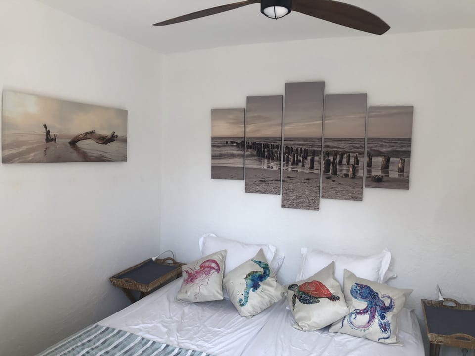 Bedroom with ceiling fan and beds that can be separated, so friends can share.
