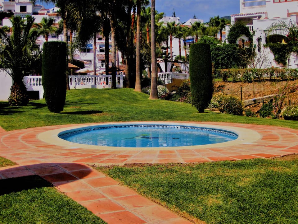Children's pool set in enclosed lush gardens.