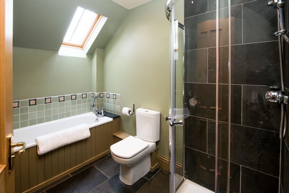 Dignity main bathroom with bath and shower