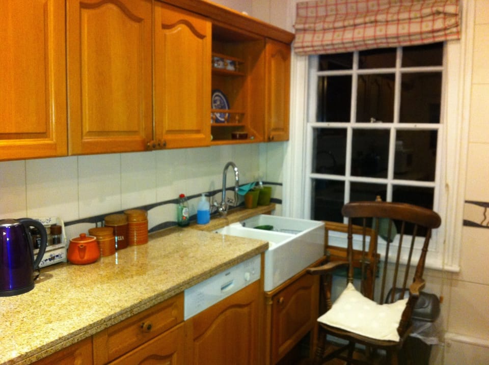 Kitchen with butler sink, dishwasher range of cupboards, granite worktops