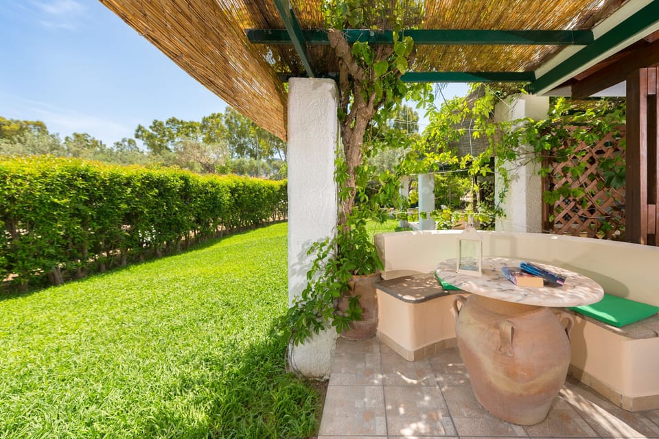 balcony with stoned table and garden view