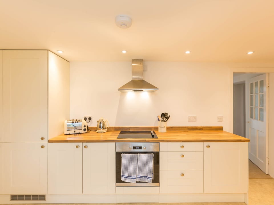 Modern kitchen with dishwasher, fridge freezer, electric hob/oven, microwave