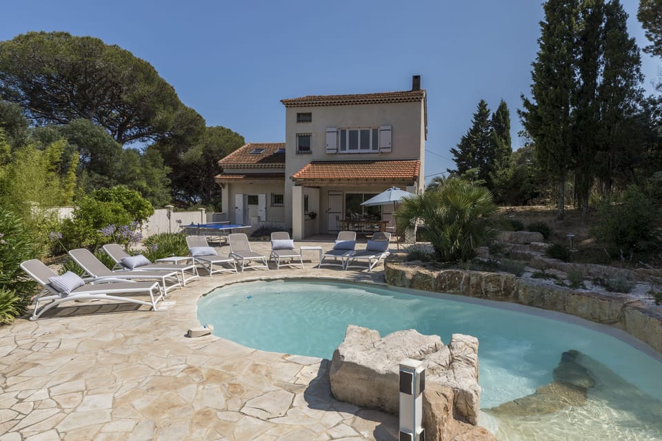 Rear view of property with pool.