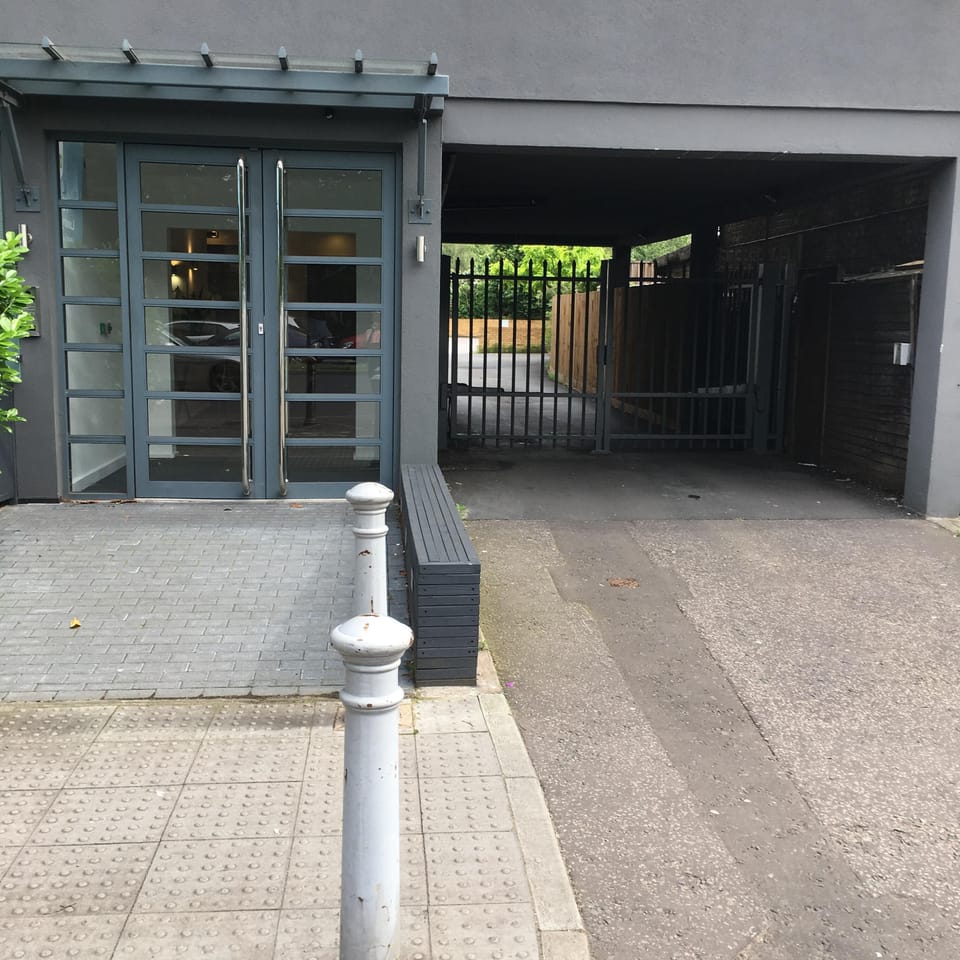 Main entrance to apartment block. Secure, gated parking to the right