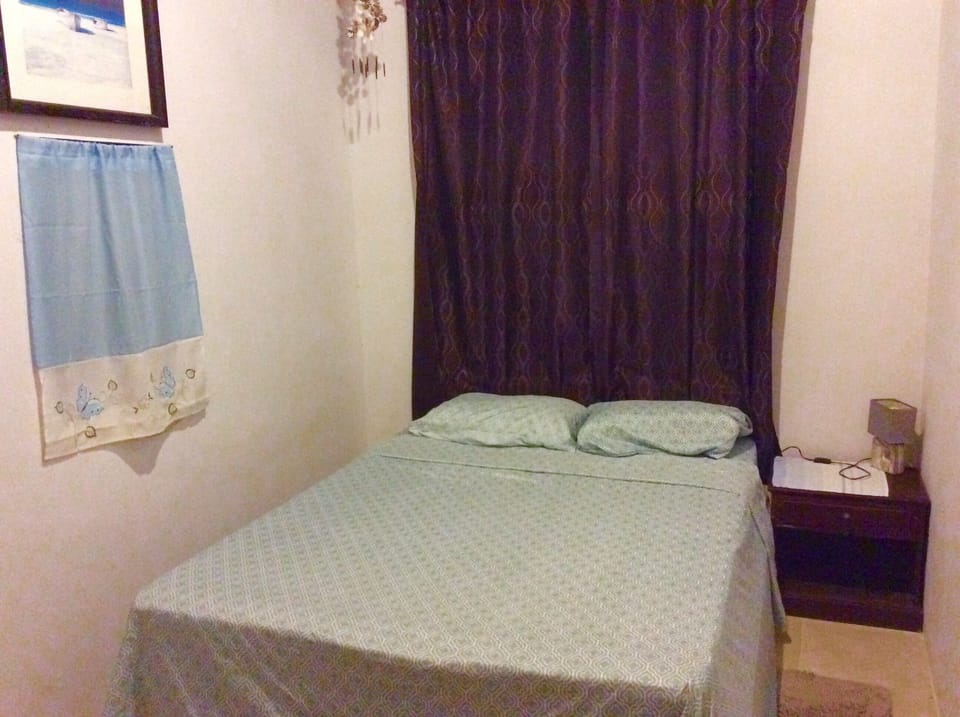 Queen sized bed with adjoining patio.