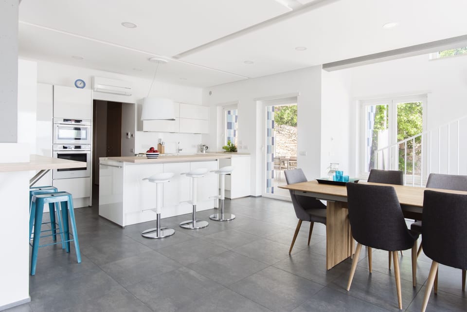 Kitchen area, which leads onto outside patio with further dining option.

