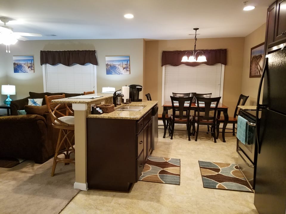 Full-size kitchen, dark cabinets, granite countertops, stainless steel appliance
