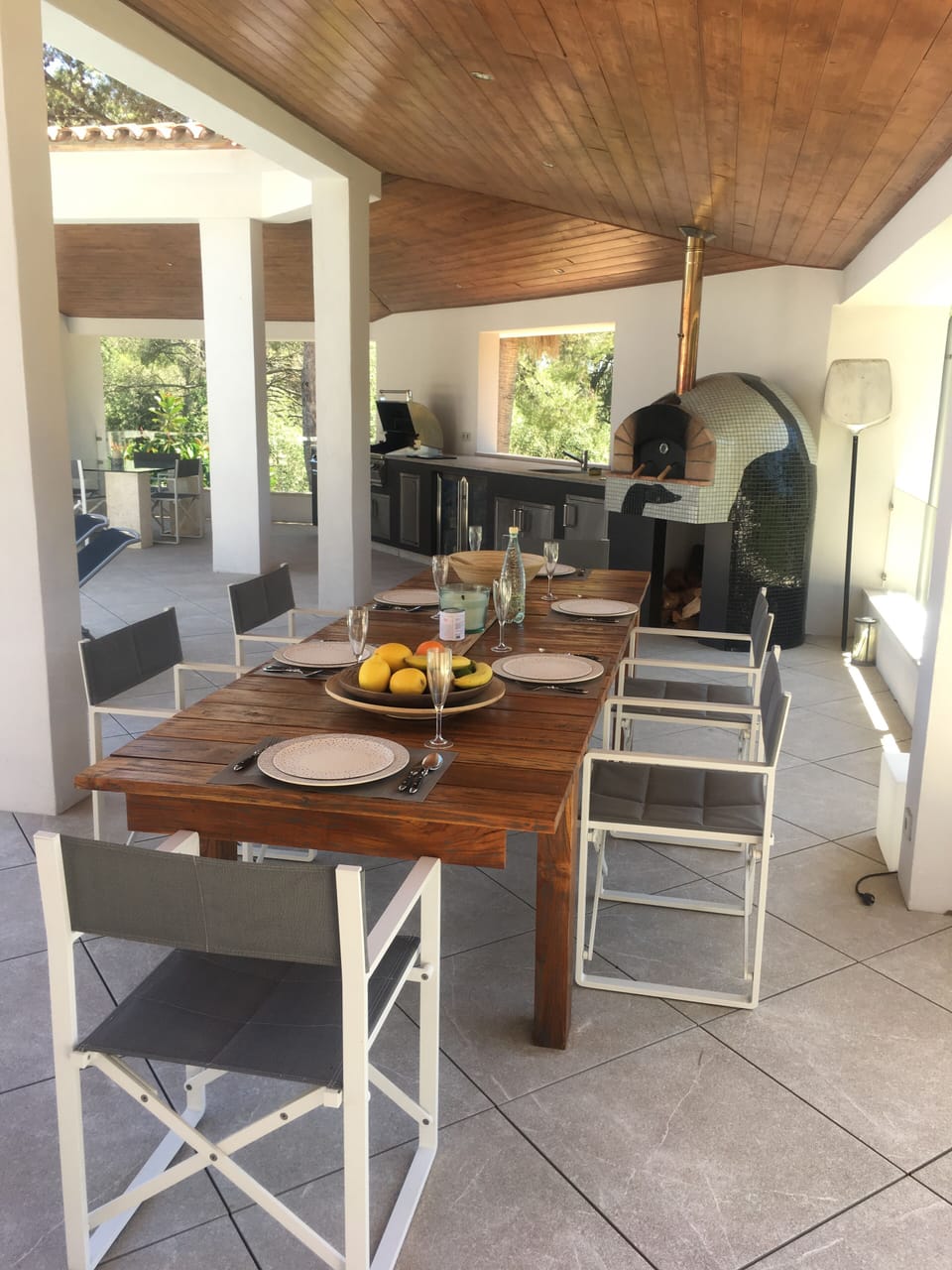 Table seats up to 10, with the wood-fired pizza oven in the background. 