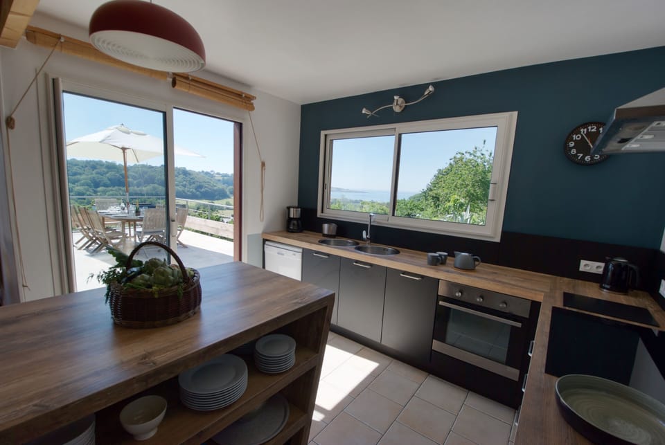 Fully equipped kitchen with two large fridges and freezer.