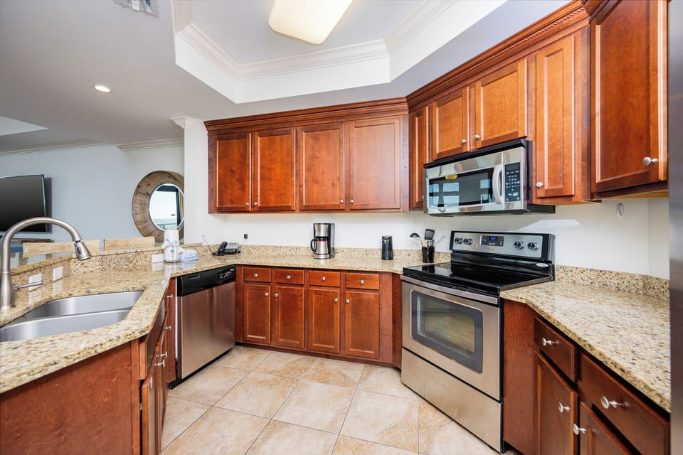 This kitchen features wood cabinetry, stainless appliances, and a convenient coffee maker for a delightful cooking experience