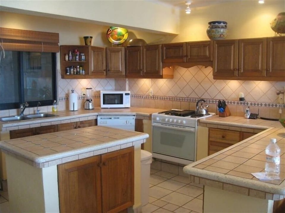 Kitchen with new refrigerator and microwave - in-unit water purifier