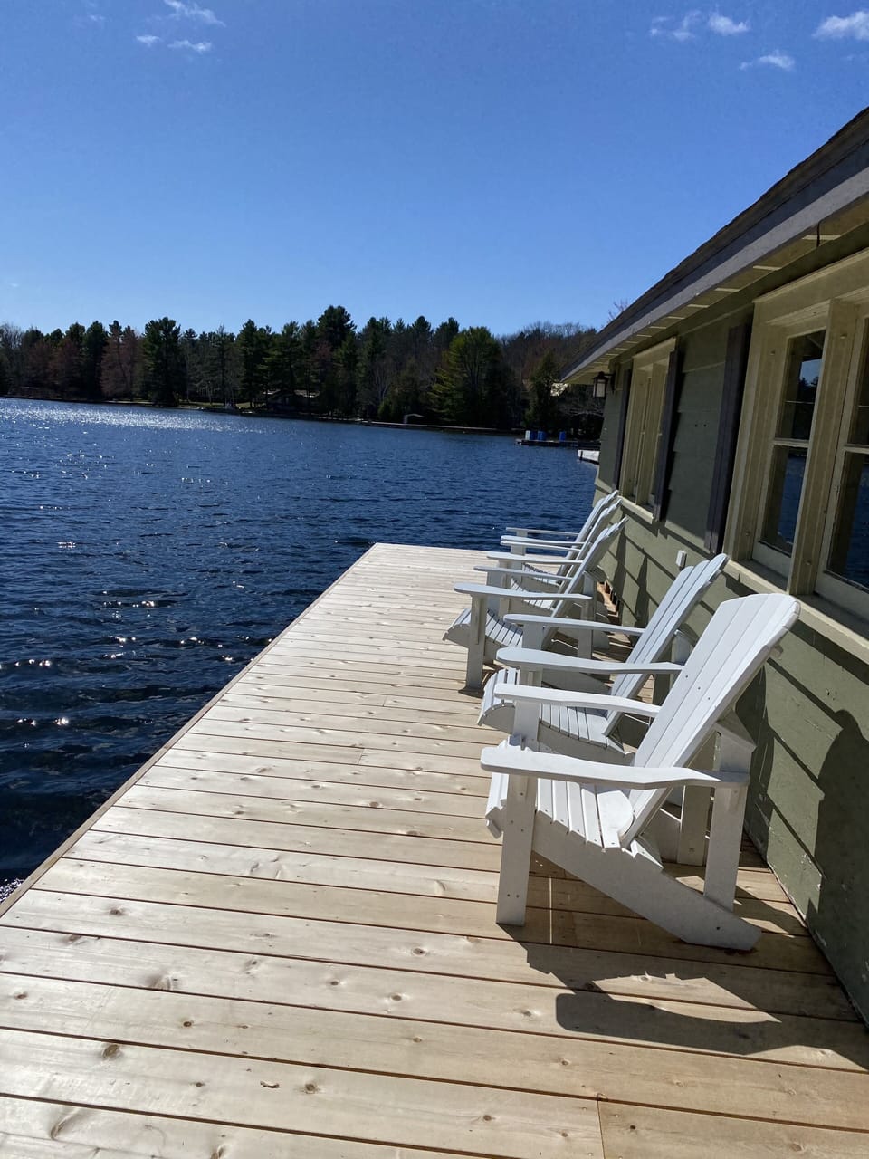 Dock with 6 muskoka chairs facing the lake