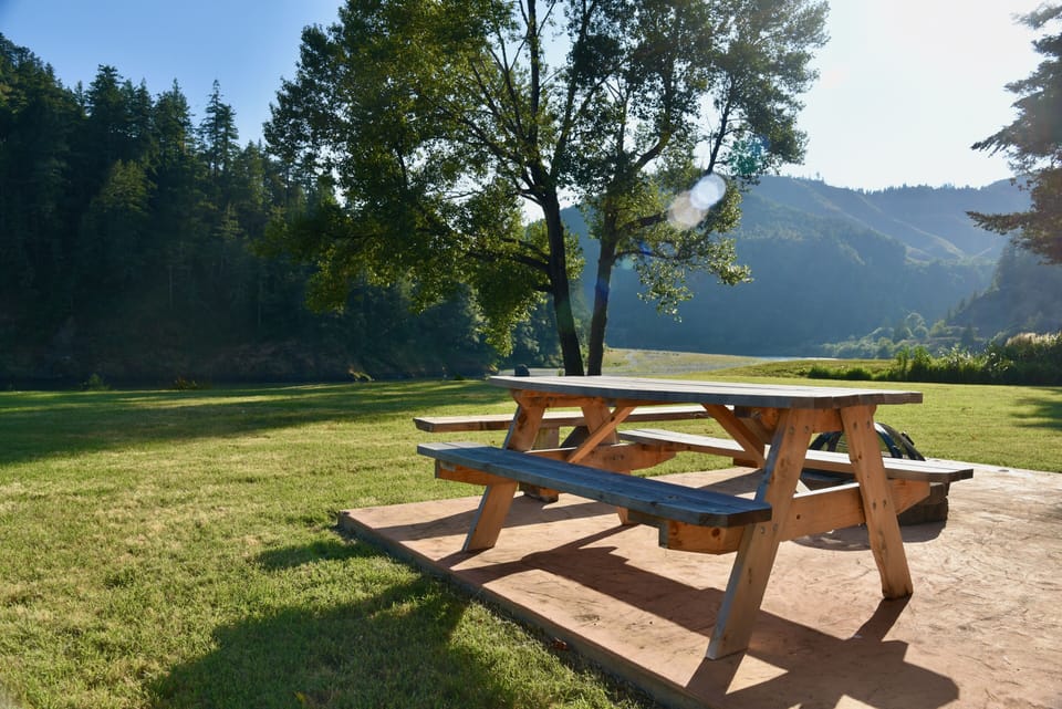 A large lawn leads to the trail down to the river