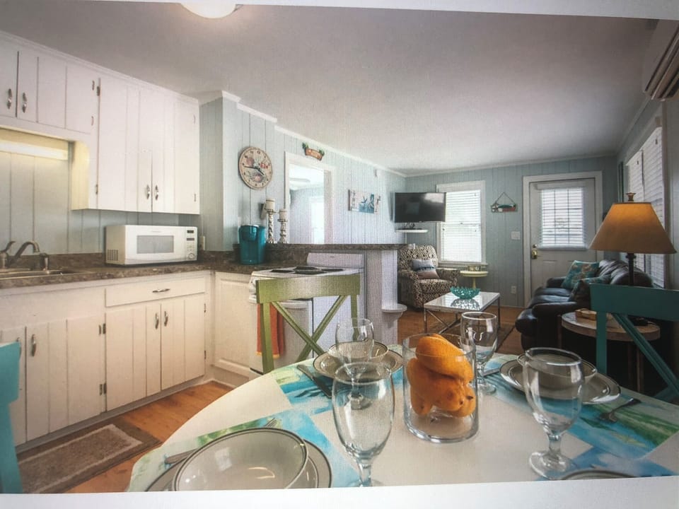 Kitchen with stove, fridge, microwave, coffeemaker, toaster, pots, pans +