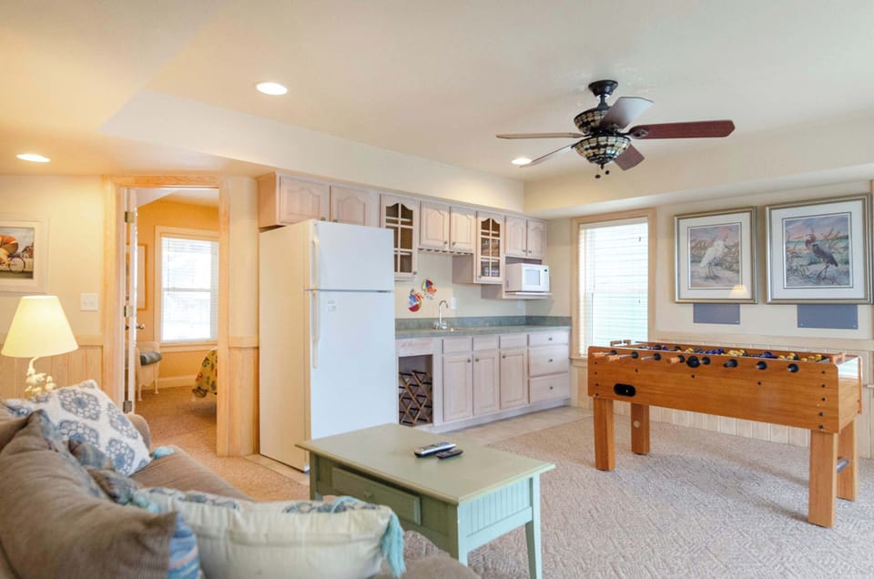 Game room with wet bar and fridge. Sliding door walks out to pool area