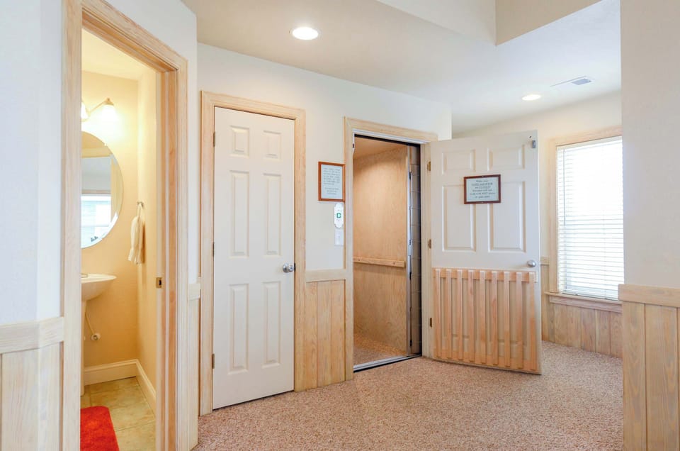 Top floor elevator next to half bath