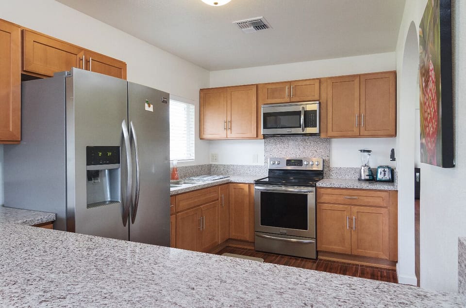 View of the kitchen from the family room area. Cupboards are full of amenities