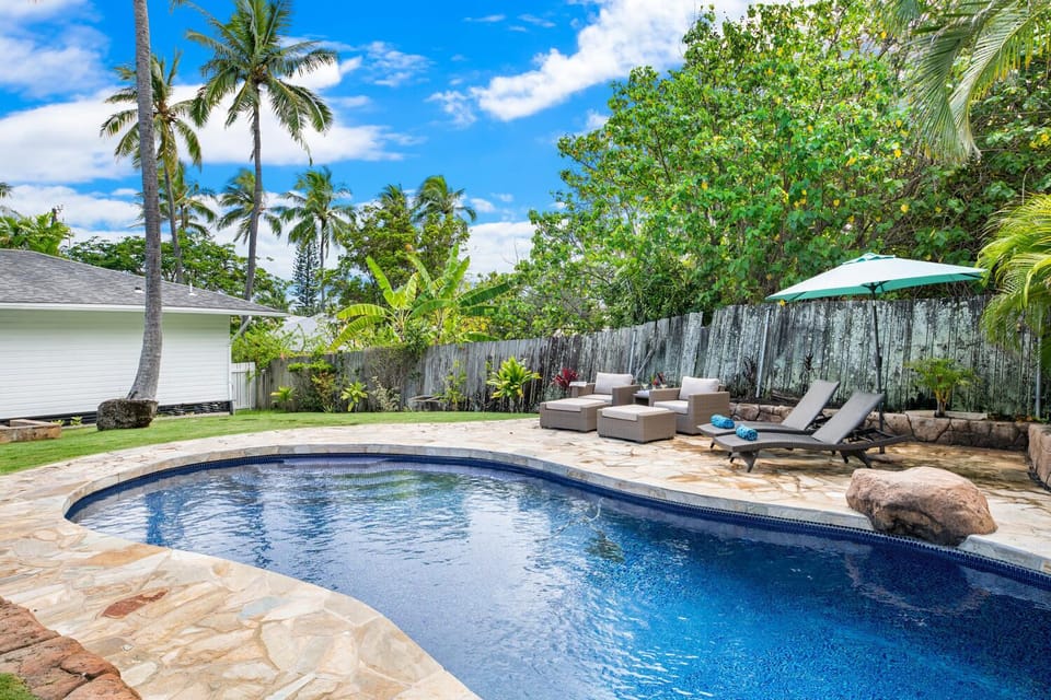 Unwind by the private pool at Lanikai Cottage, surrounded by tropical greenery and island breezes.