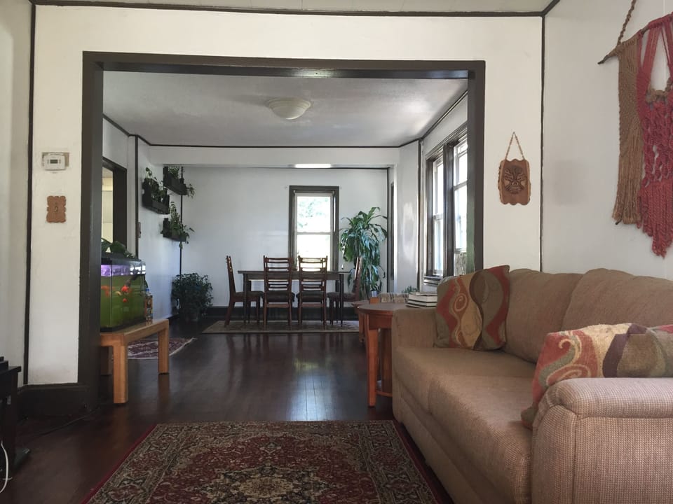 Open concept living and dining room which features a 30 gallon fish aquarium.