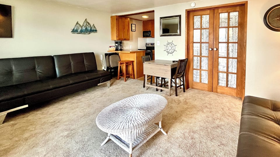 View from great room toward kitchen and bedroom - with bedroom french doors closed
