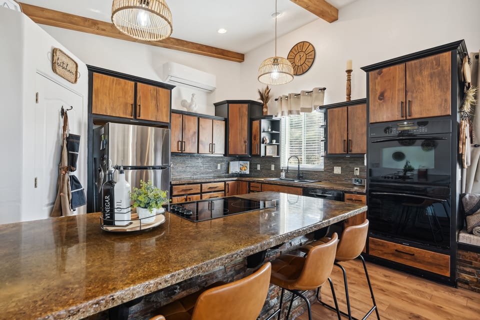 fully furnished kitchen with double oven, cooktop, dishwasher, and microwave