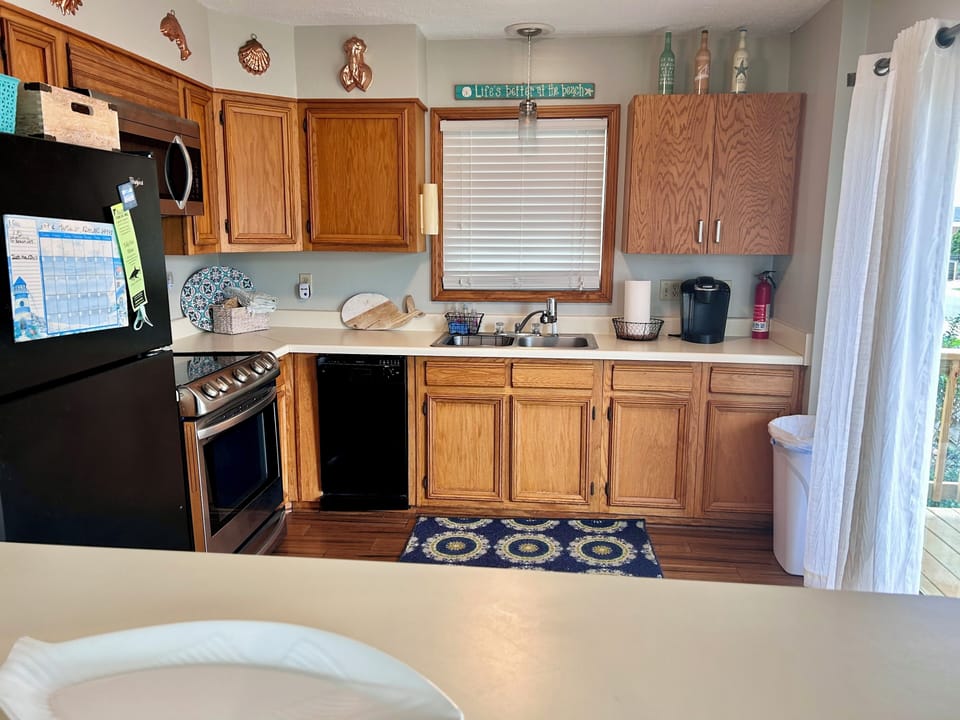 Kitchen features a Keurig and new pots and pans. 