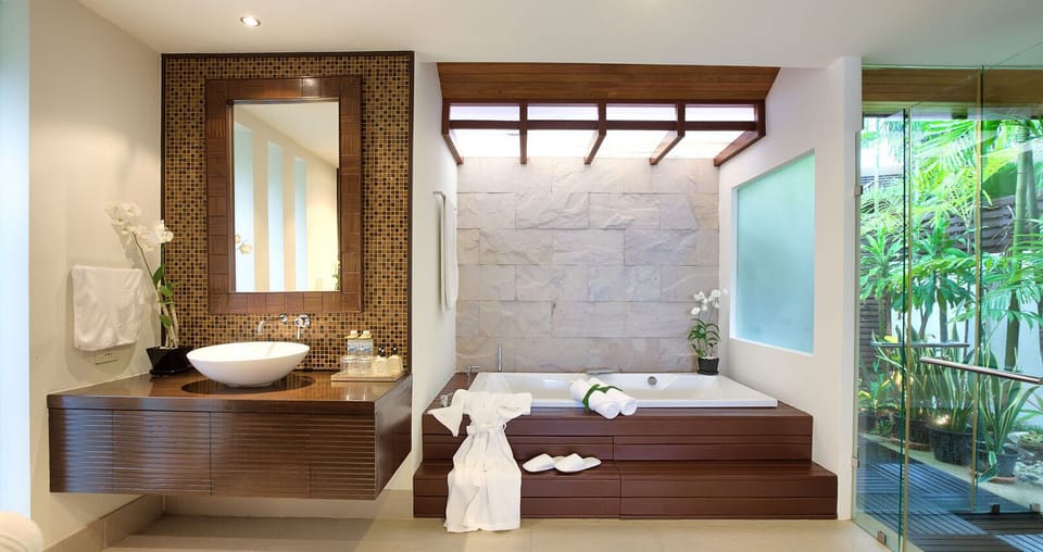 En-suite bathroom with dual vanity, indoor bathtub and rainshower