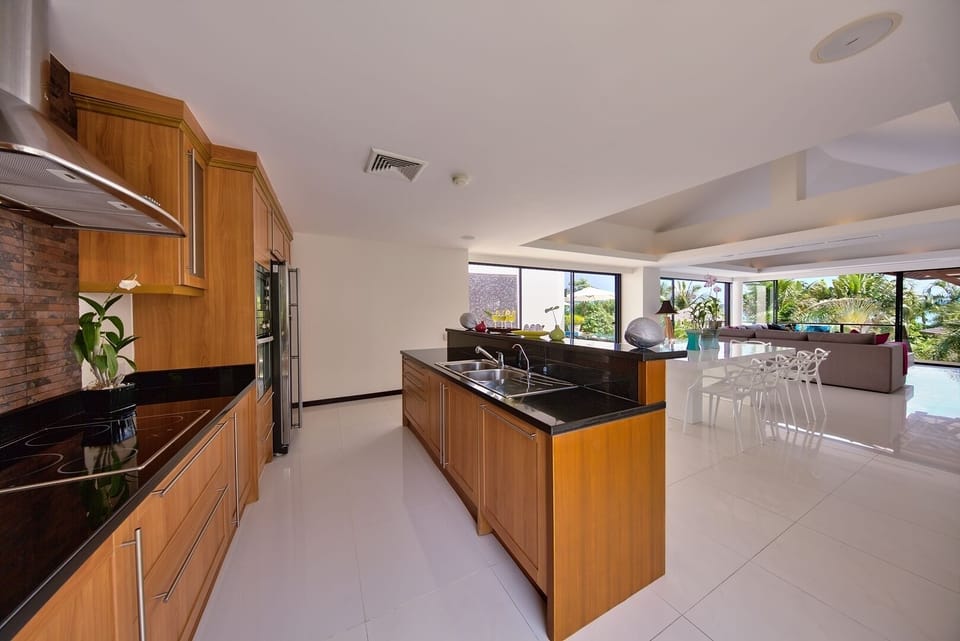 Fully-equipped kitchen with electric stove top, oven, microwave, blender, & more