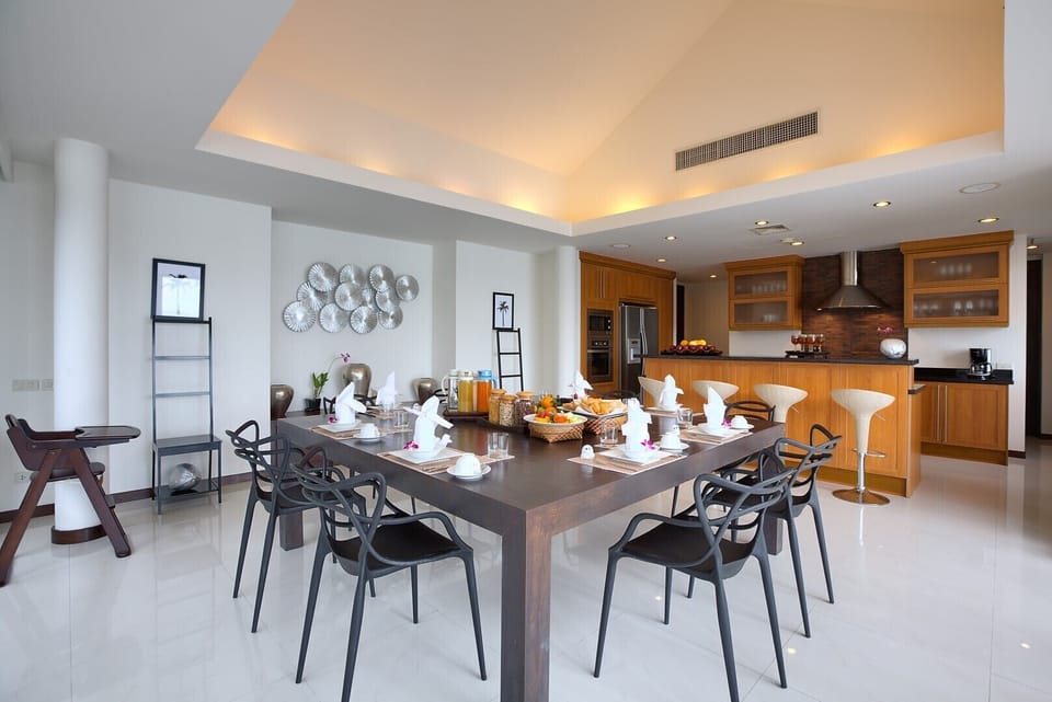 Indoor dining area with square dining table that can seat 12 persons.