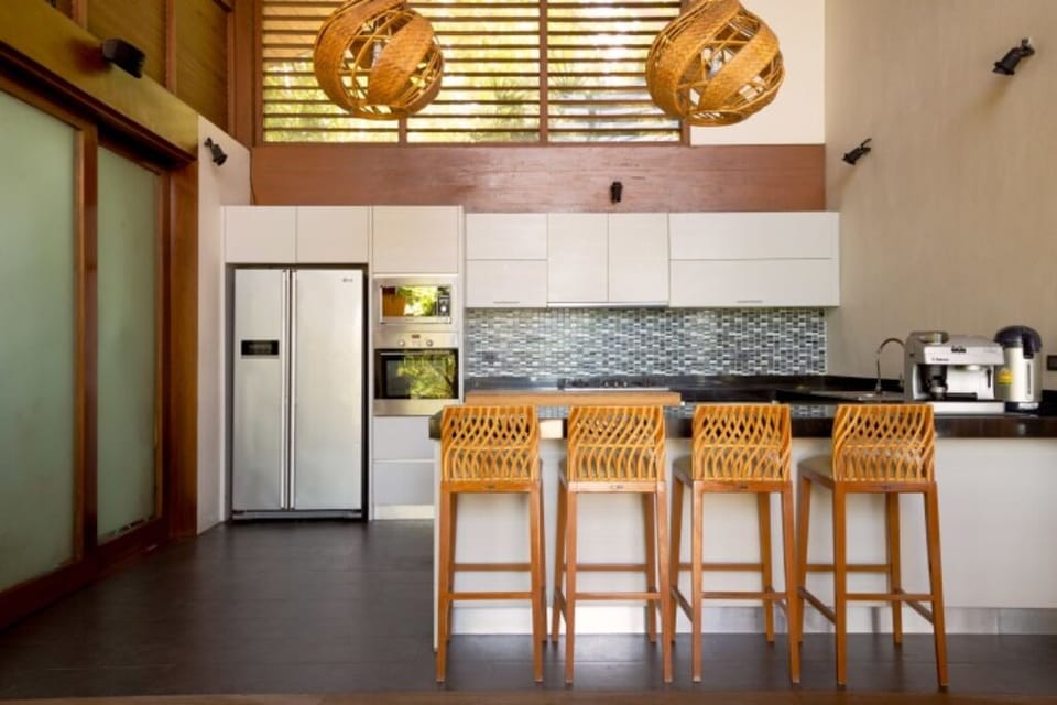 Well-equipped kitchen with oven, coffee machine, stove top, blender, and more