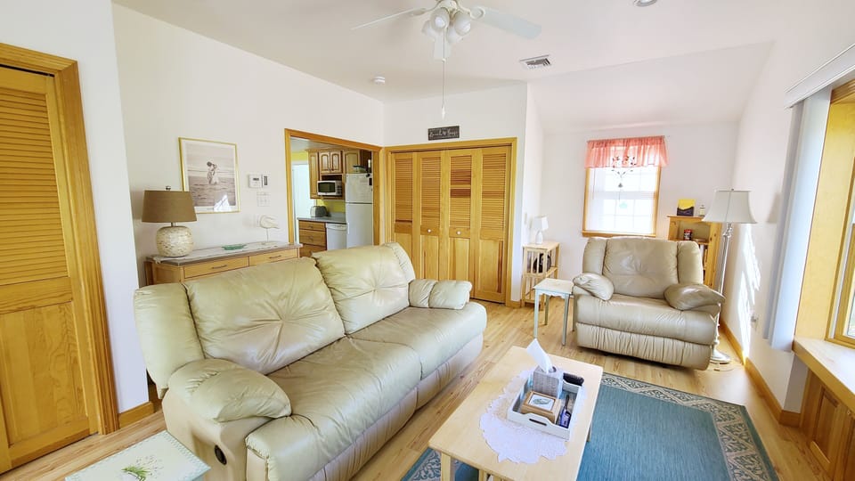 Living room has comfortable seating and flat screen TV