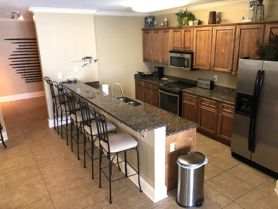 Large well stocked kitchen with premium cabinets, granite, stainless appliances 