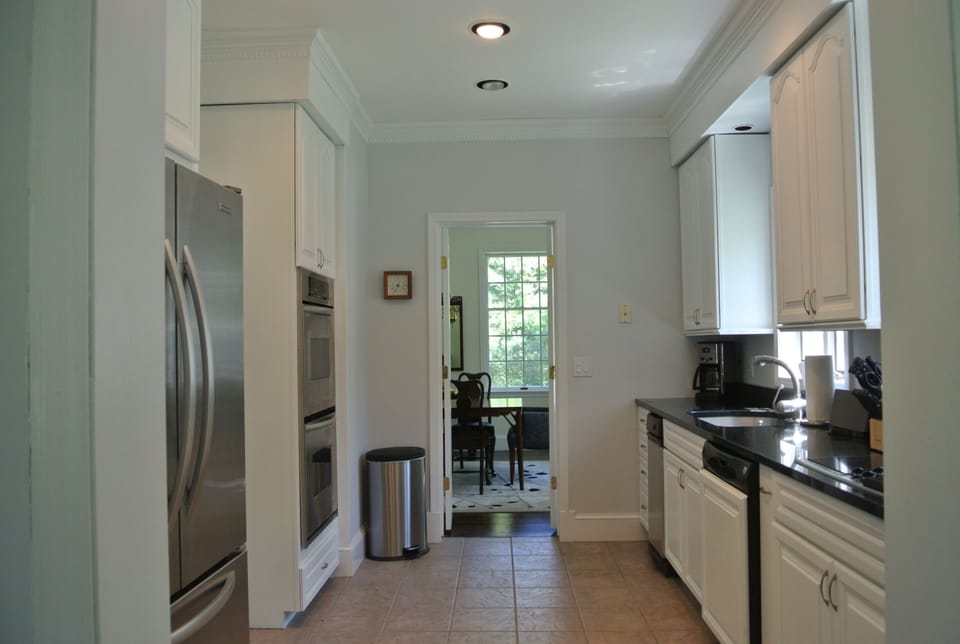 Renovated country kitchen with granite counters and stainless appliances