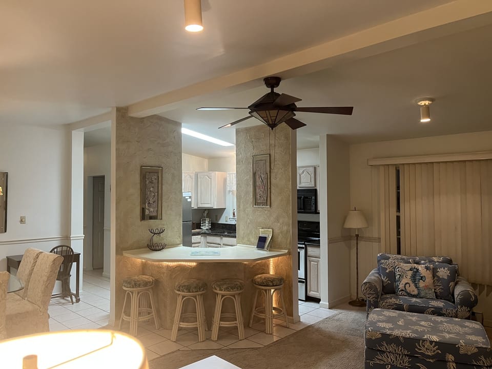 Great room w kitchen breakfast bar dining room living room + entrance to sunroom