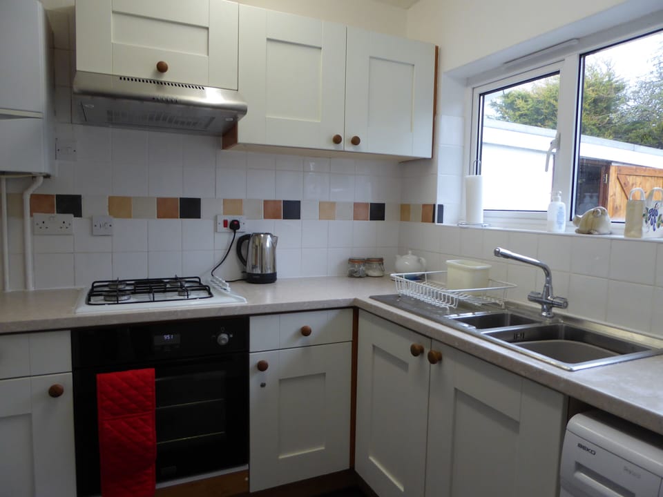 Modern fitted kitchen with washing machine, fridge/freezer and microwave
