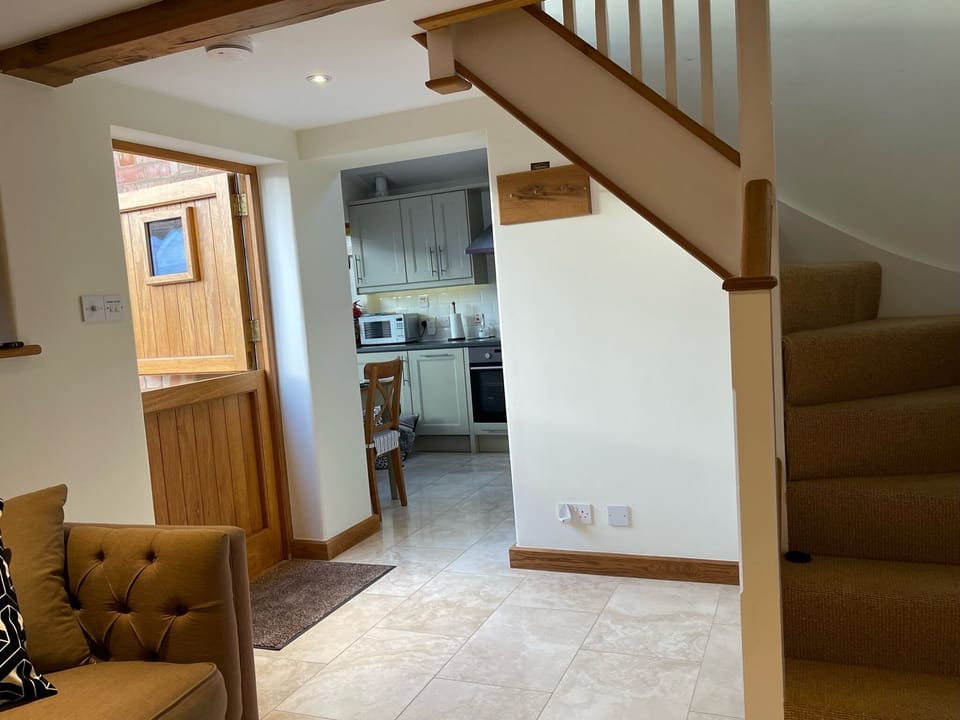 Stable door and view from living room to kitchen and upstairs