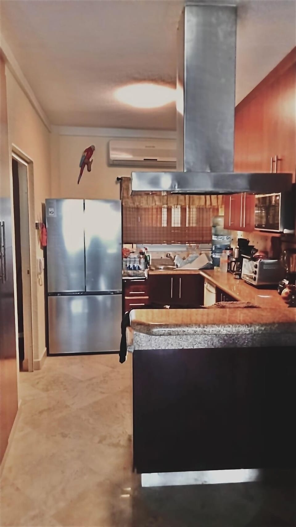 Kitchen has a new stainless steel refrigerator