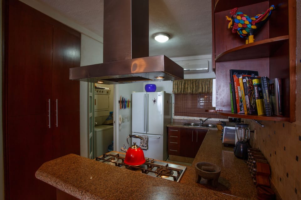Kitchen with pantry and laundry room with stackable full size washer and dryer.