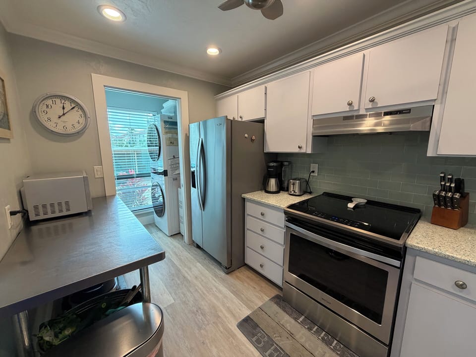Your fully-equipped kitchen invites culinary adventures with granite counters, stainless appliances, and convenient laundry access.