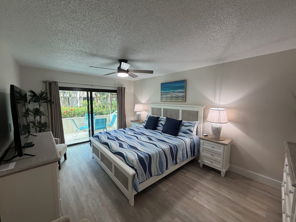 Your spacious master bedroom features a comfortable bed and sliding doors to your private patio retreat.
