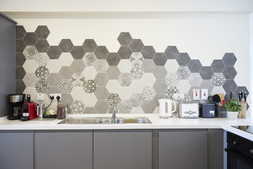 Kitchen with washer-dryer, fridge freezer, oven and hob and  2 coffee machines