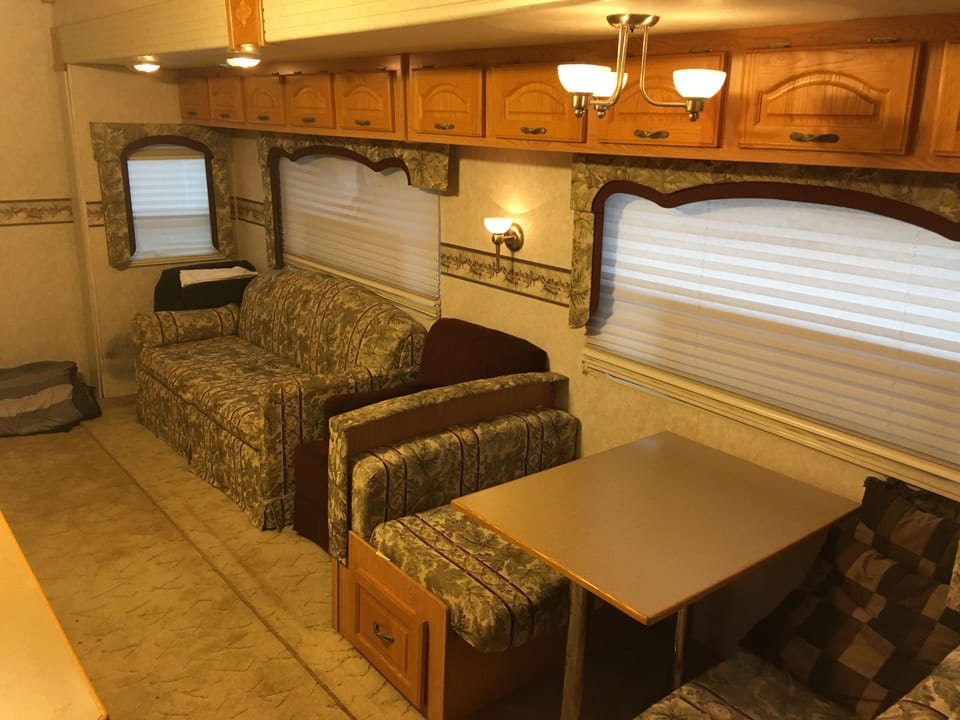 Living room slide out with full size hideaway couch and twin fold down table.