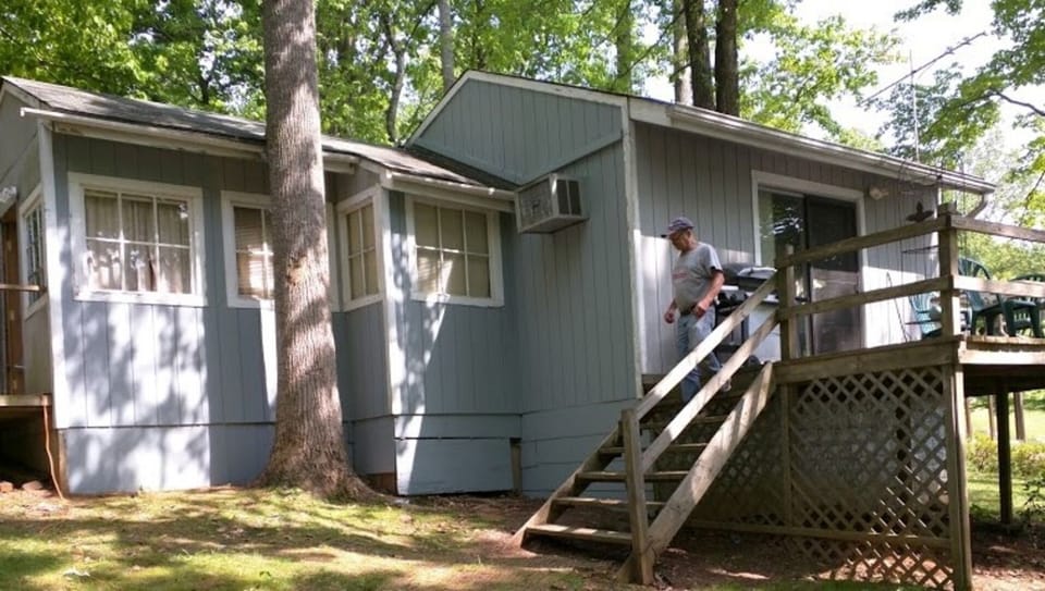 Rustic cabin with a view of lake from three sides of the house.