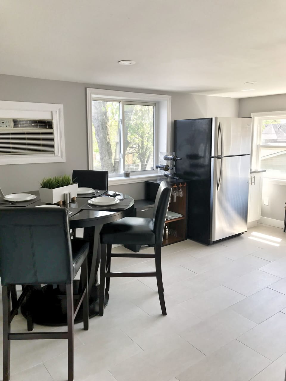 Kitchen with dry bar, fridge, stove and Kureig. 