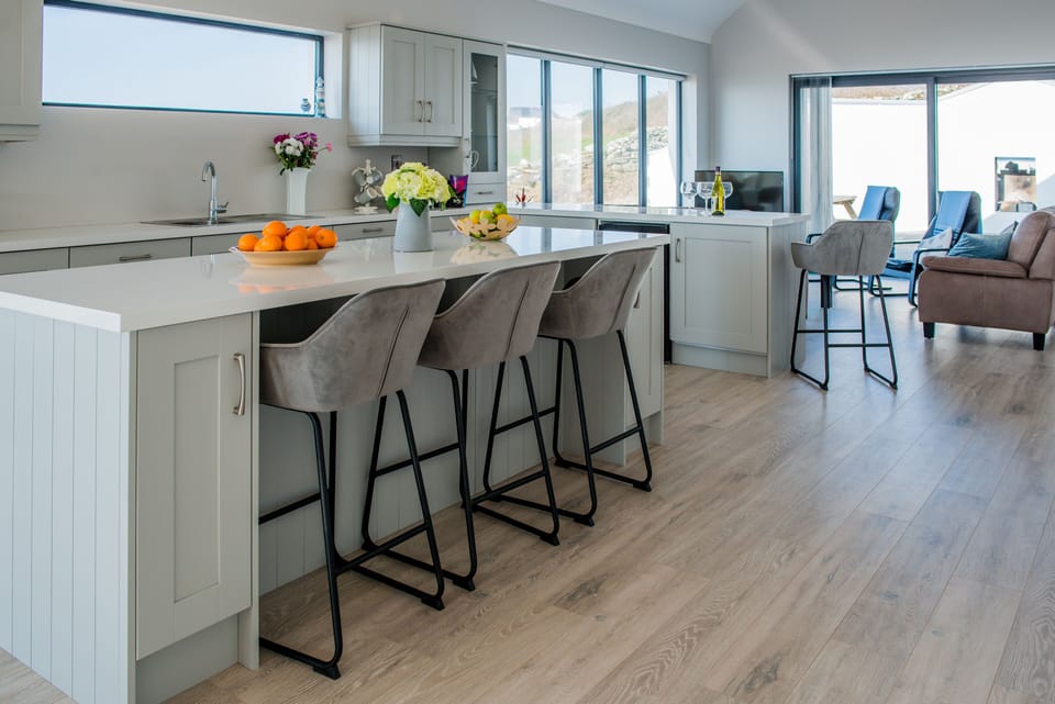 Living space with floor to ceiling windows facing the ocean 