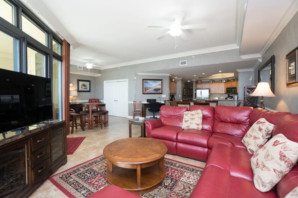 Living room with sectional sofa and flat screen TV.