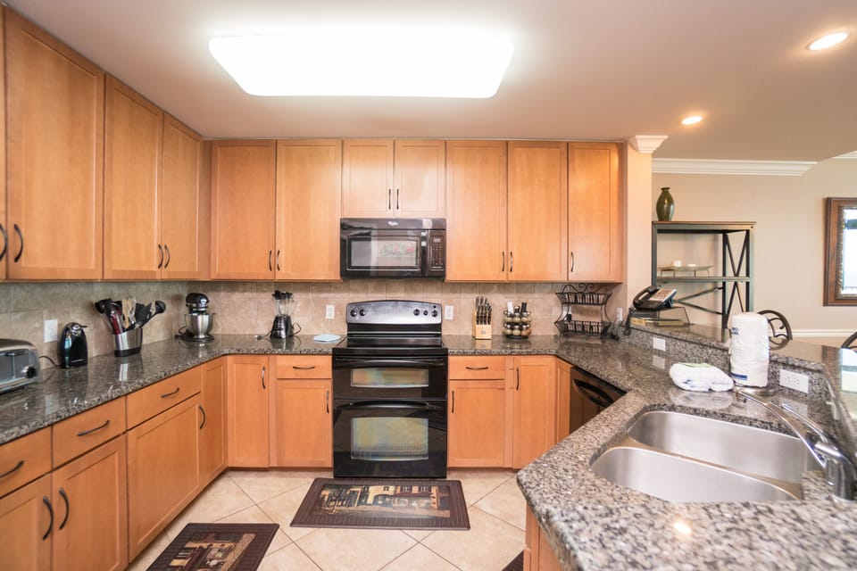 Kitchen with double oven, microwave, dishwasher, toaster, coffee pot, etc.