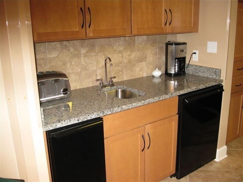 Extra counter space with under counter ice maker and soft drink refrigerator.
