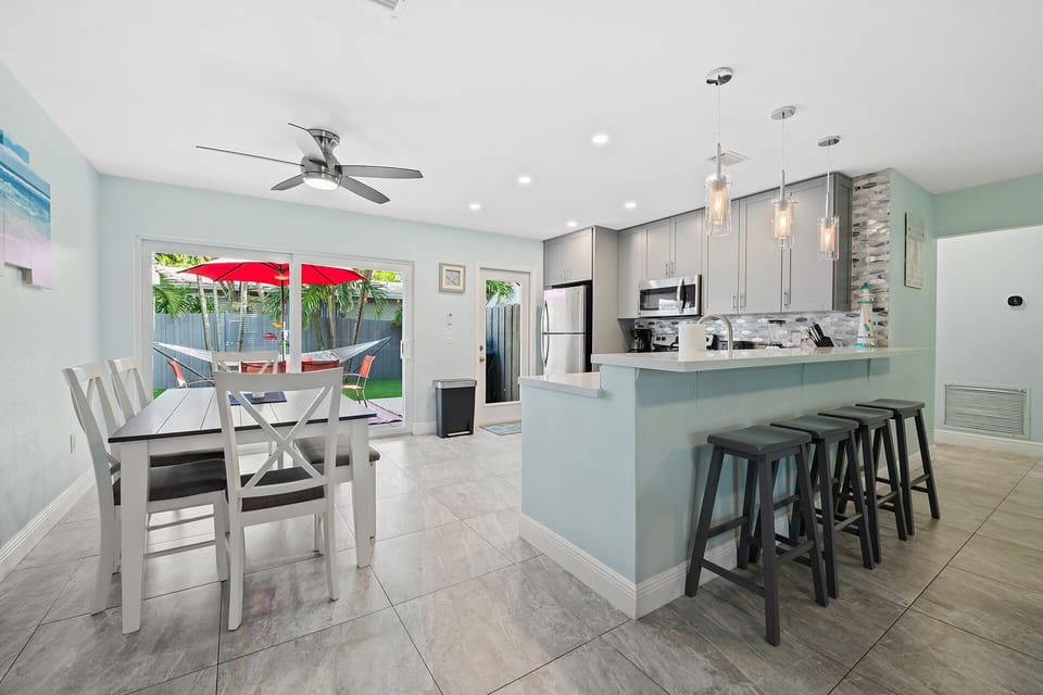 lots of seating with dining table and peninsula stools